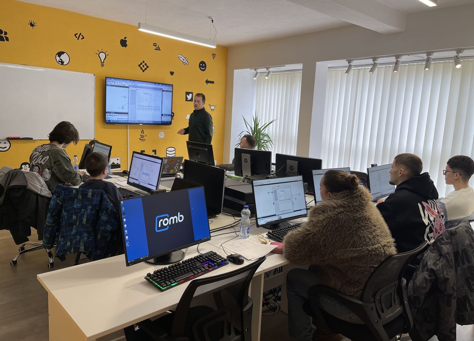 A class in progress at the Romb centre in Gjakova, with the Romb logo on a screen